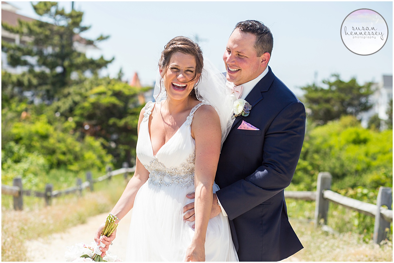 Couple laugh on the beach at their Icona Golden Inn Wedding - Photography by Susan Hennessey Photography