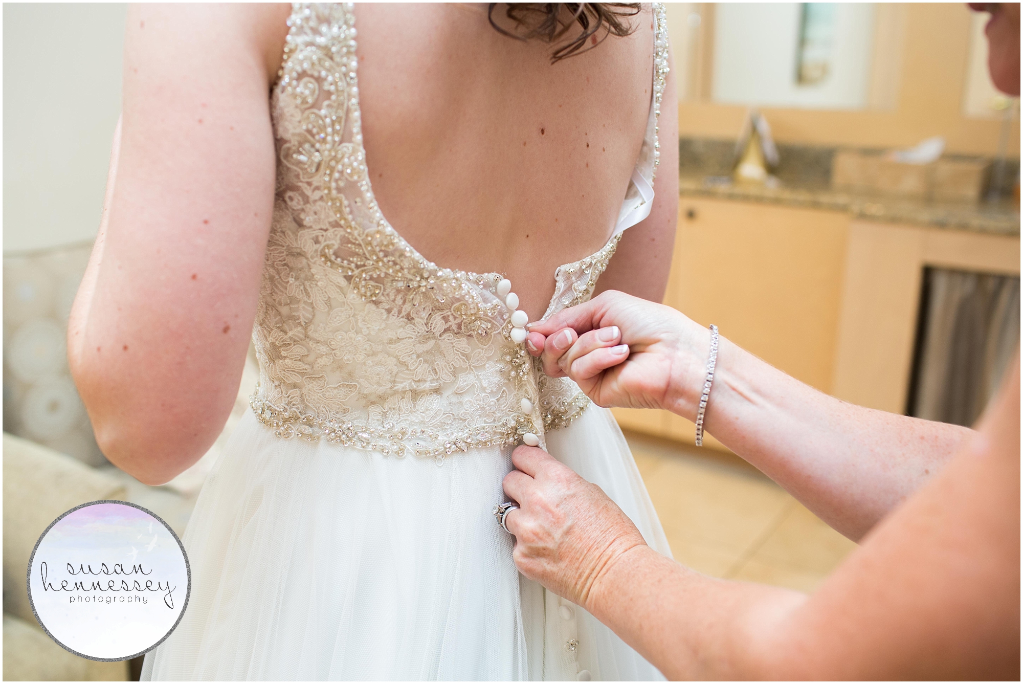 zipping up the wedding dress