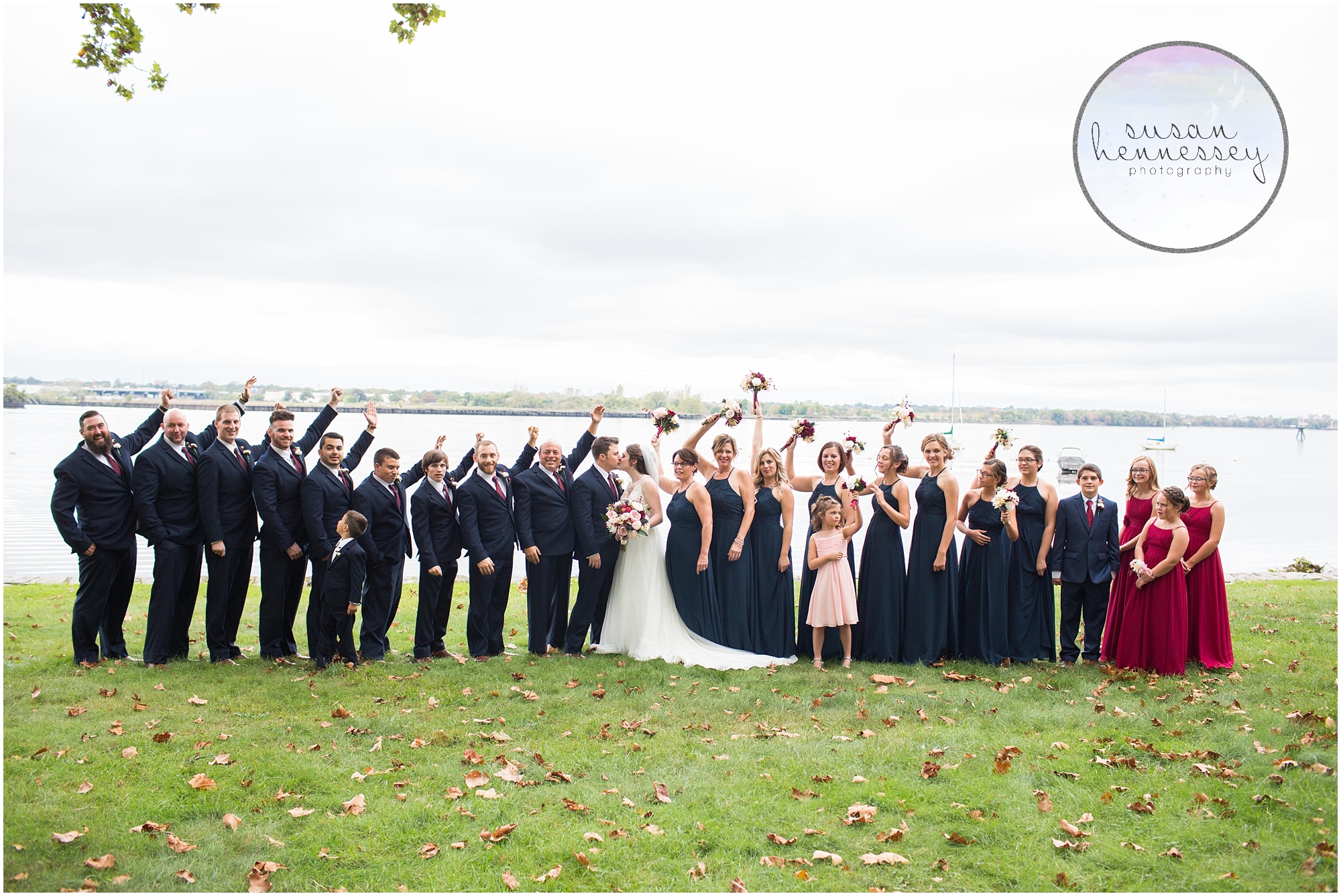bridesmaids and groomsmen celebrate with the couple 