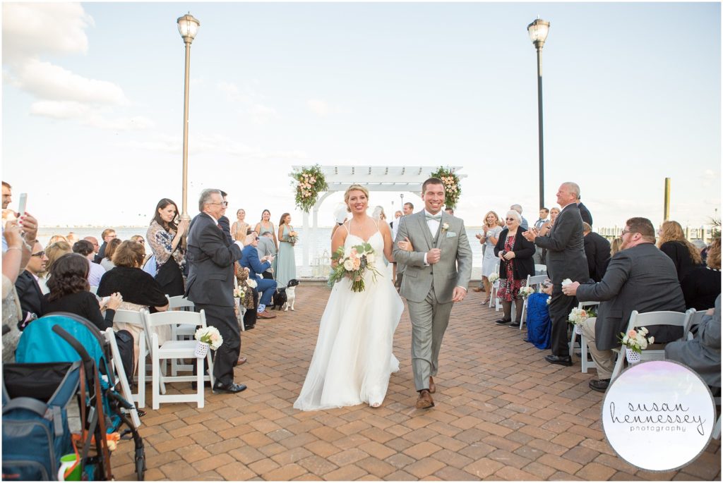 Happy couple walk down aisle at Martell's Waters Edge Wedding