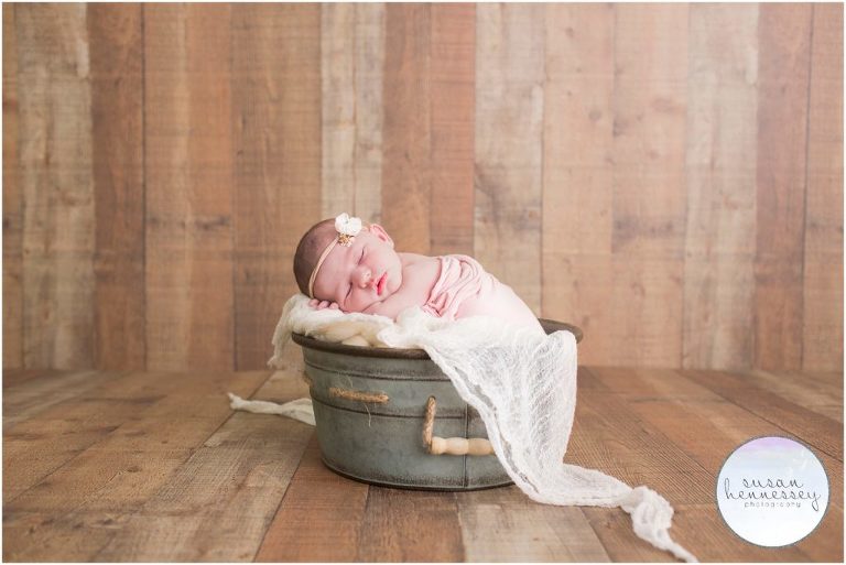 Newborn photography and rustic wood backdrop.