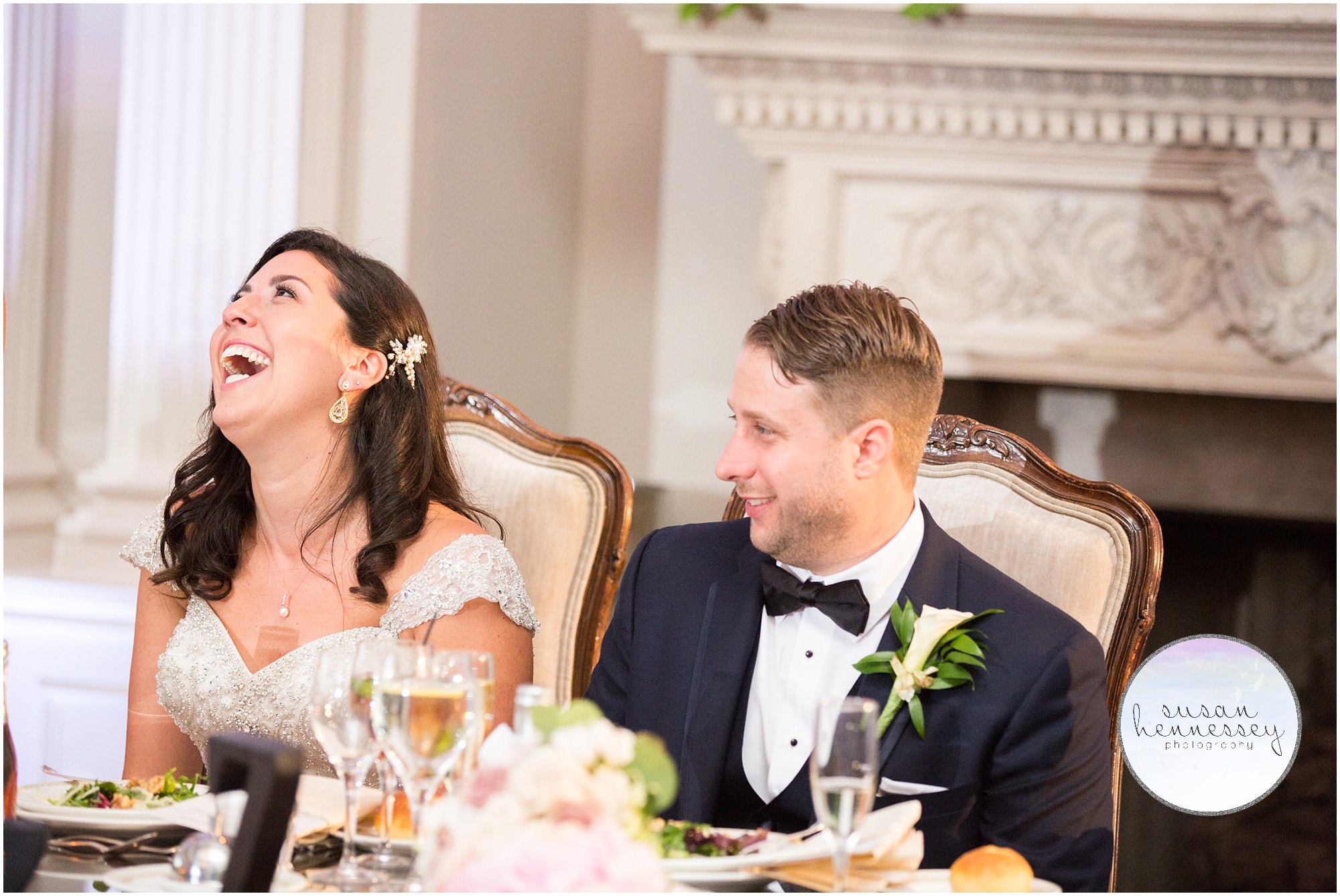 Couple laughs during toasts at reception. 