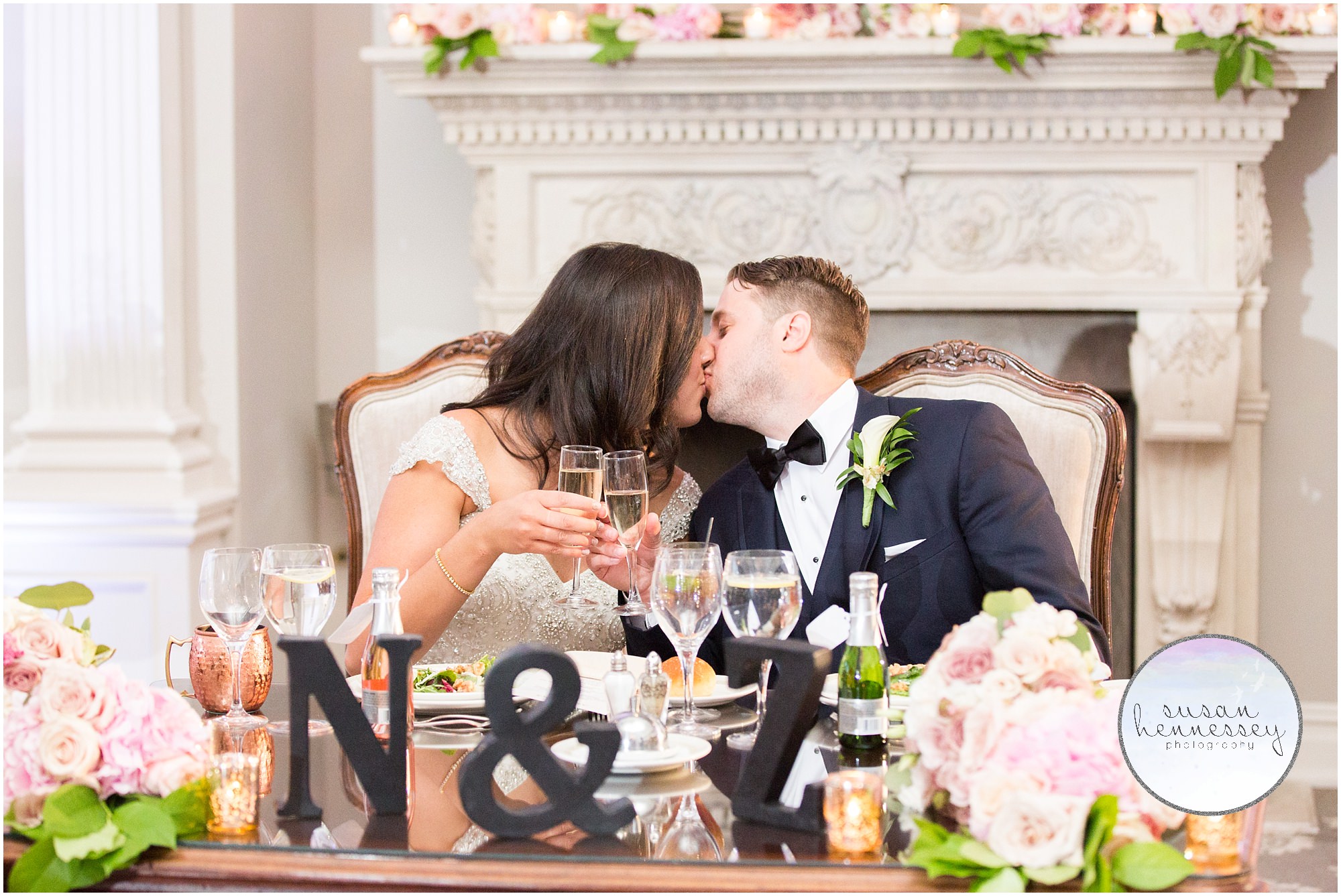 Bride and groom share kiss at sweetheart table at park savoy estate wedding. 