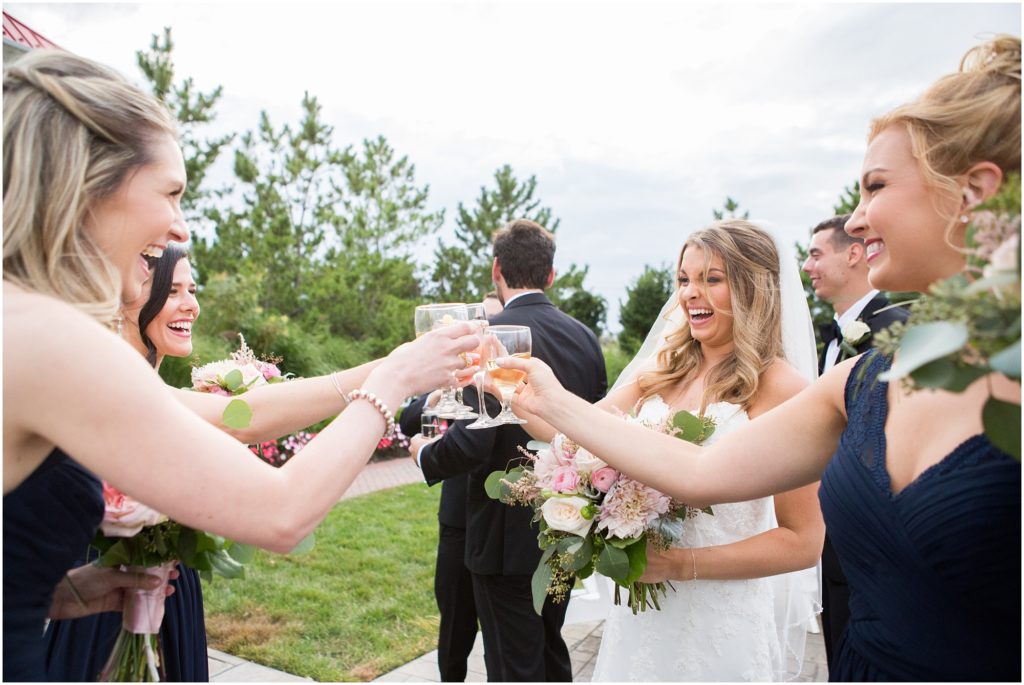 Happy bride celebrates her marriage with friends and family following their ceremony with champagne