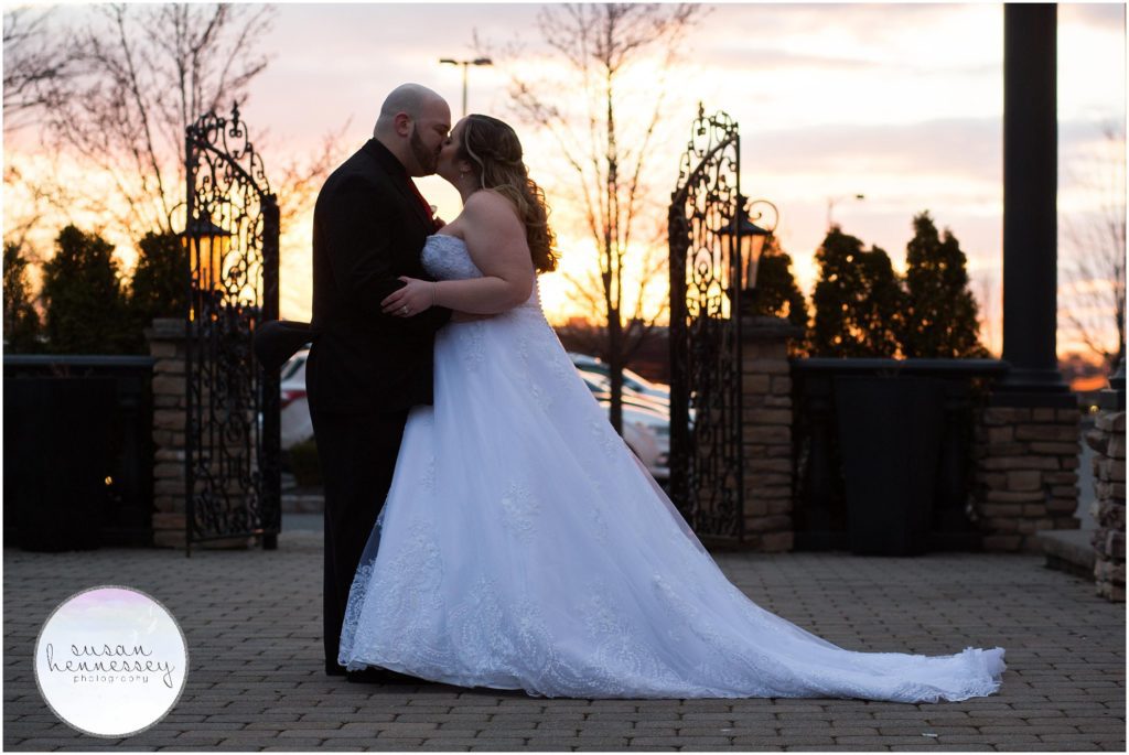 Bride and Groom kiss at sunset