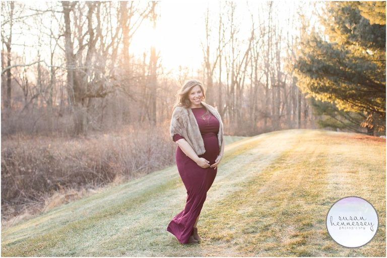 Happy pregnant woman poses for her maternity session. 