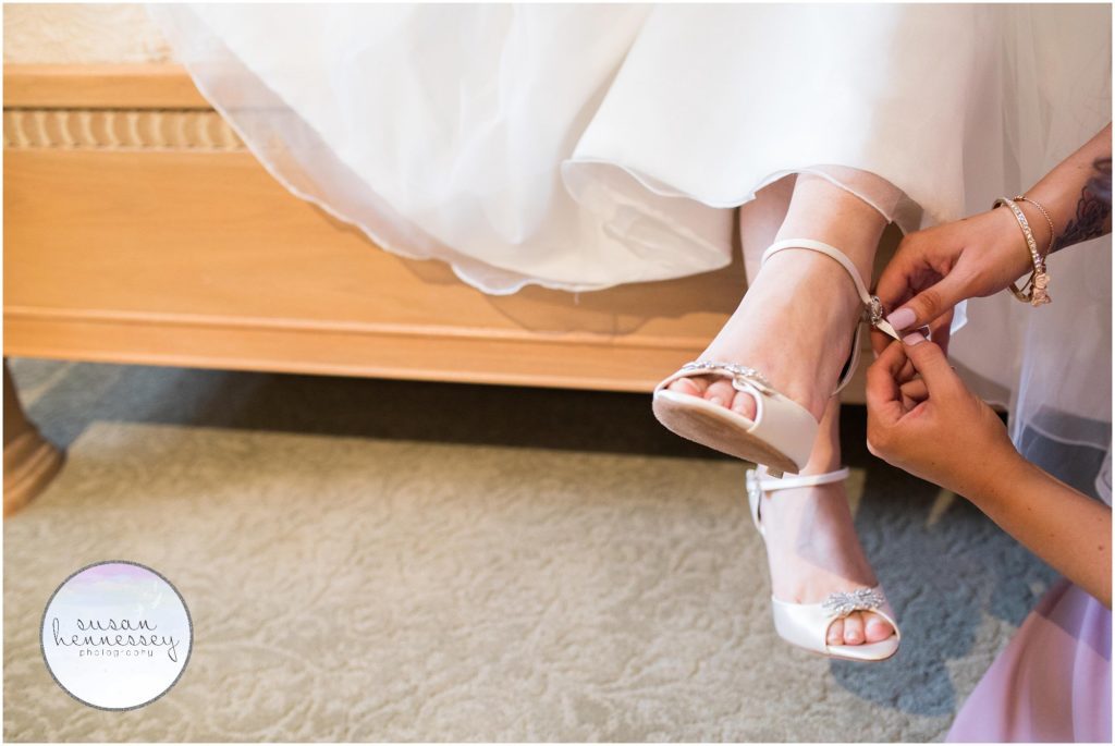 Bride puts on her shoes for her winter wedding
