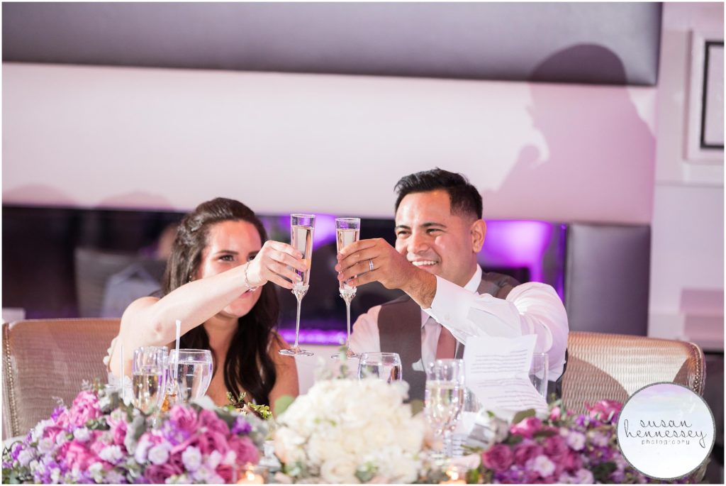 Bride and groom during champagne toasts at their Watermill Caterers Wedding
