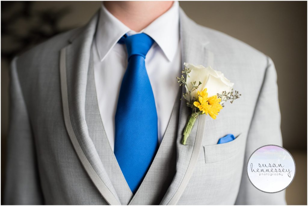 detail photo of groom's boutonniere and tie.
