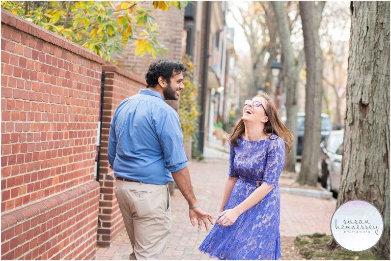 An engaged couple laughs at their Fall engagement session in Philadelphia. 