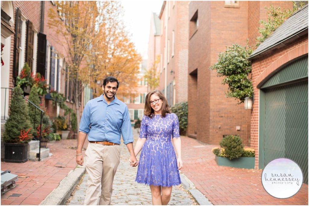 An engaged couple walks on the cobblestones in Philadephia. 