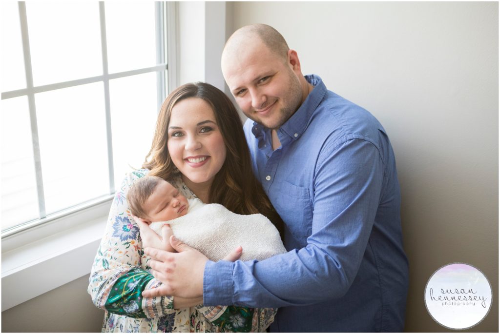 Mom and Dad cuddle their baby during Newborn Photo Session