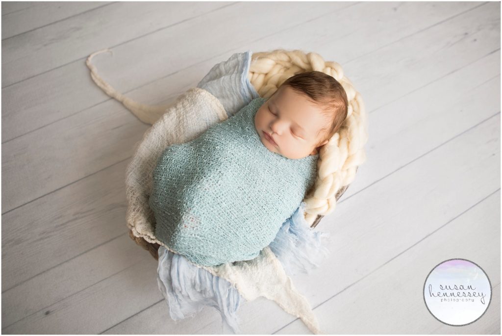 Baby boy sleeps during his newborn photography session