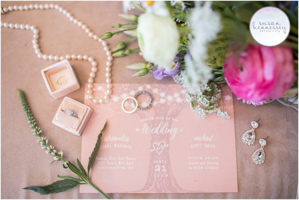 Bridal details at Running Deer wedding, wedding rings, bouquet, Mrs Box, invitation and earrings.