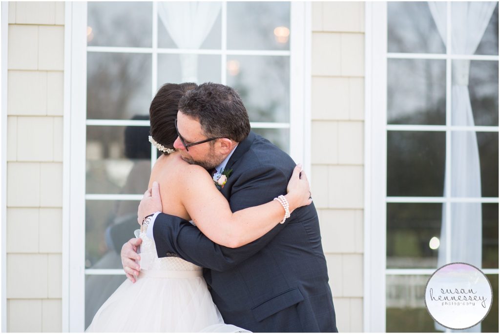 Bride hugs her father during first look.