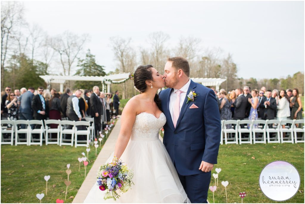Couple kiss at Ceremony at Running Deer Golf Club