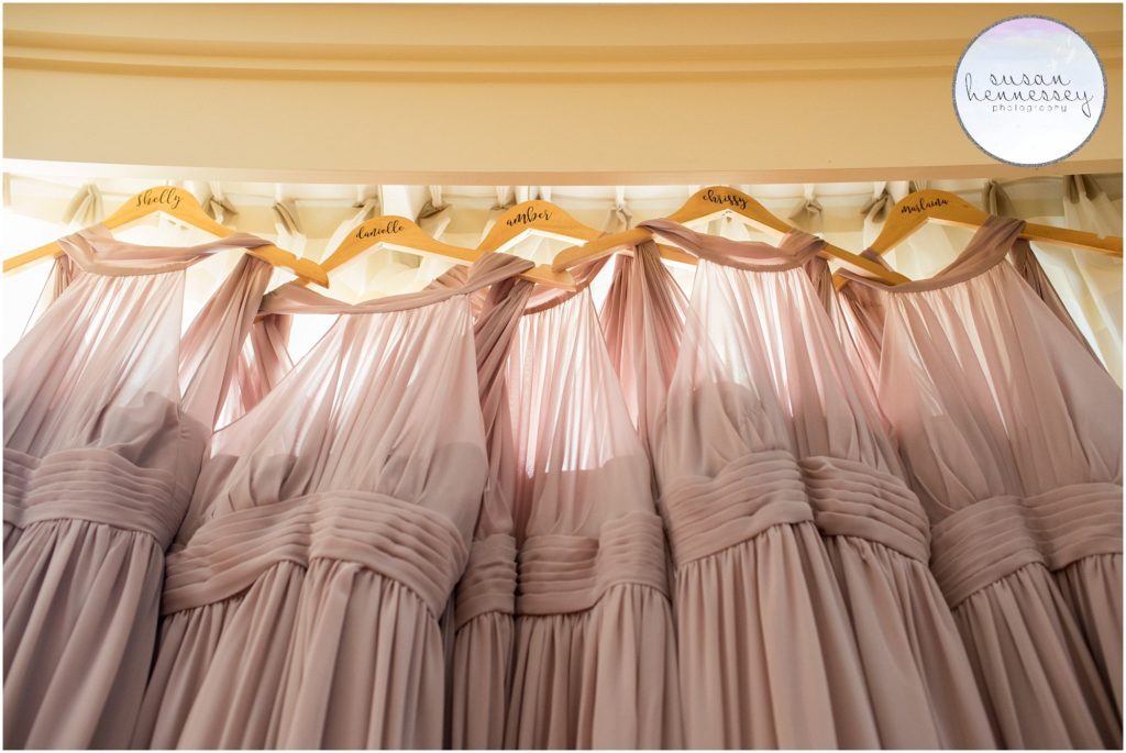 Matching bridesmaid dresses from Azazie on personalized hangers.