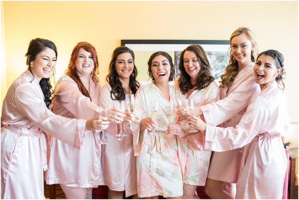 Bride and Bridesmaids drink champagne