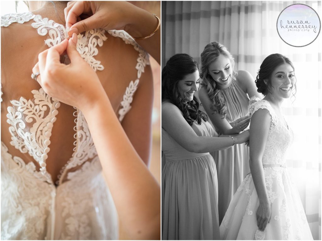 Bride's sisters help bride into her Stella York wedding gown. 
