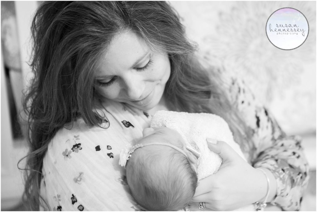 Black and white portrait of mother holding her baby girl. 