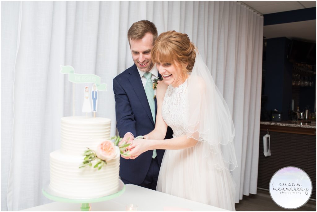 Bride and groom cut cake during wedding reception at the windrift hotel