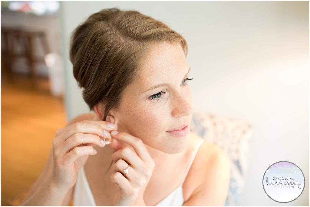 Bride puts on earrings for her Cape May wedding.