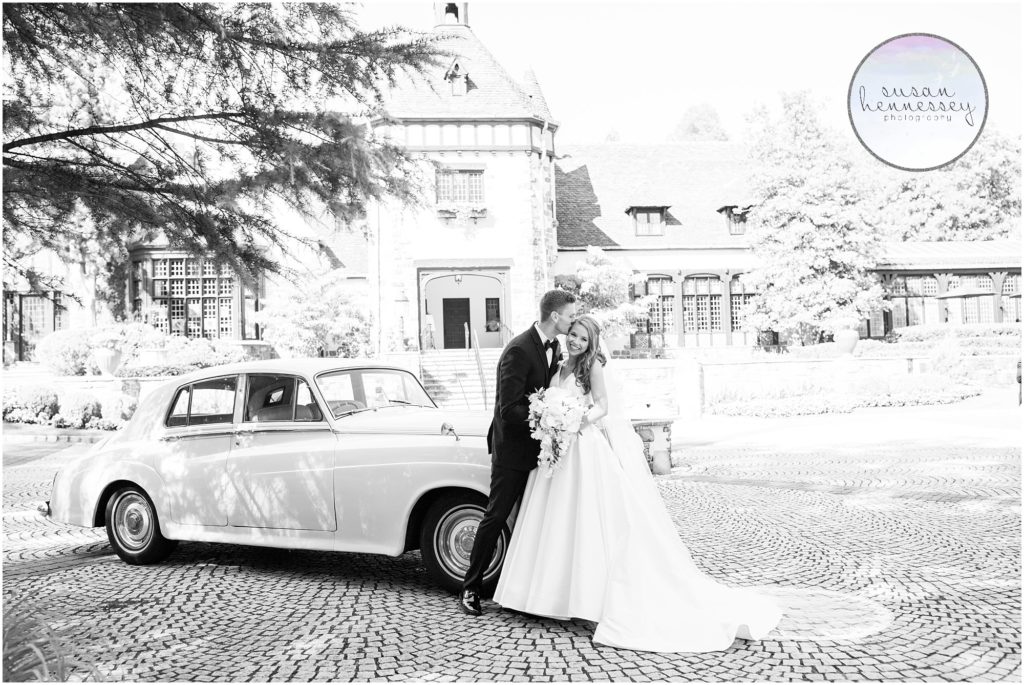 Bride and groom with their vintage car on their wedding day at pleasantdale chateau