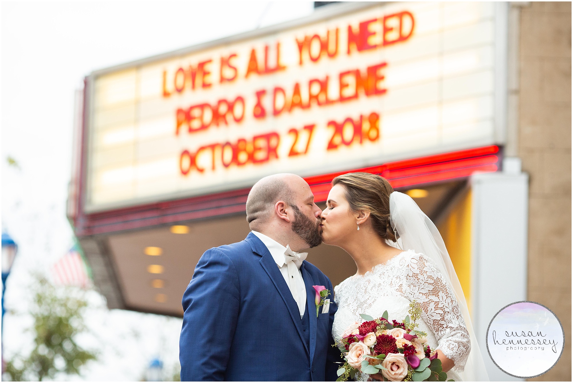 Bride and Groom pose in front of the Colonial Theatre marquee during their Phoenixville Foundry Wedding