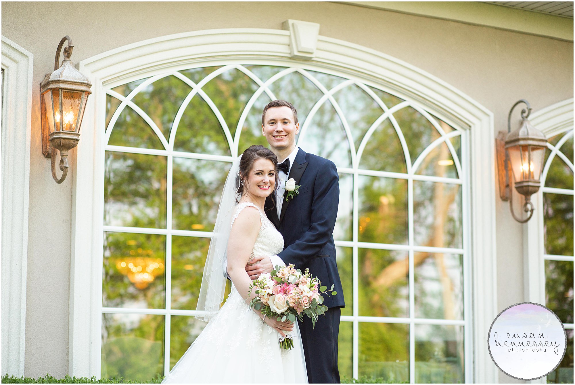 Bride and groom in front of the iconic windows at the Bradford Estate