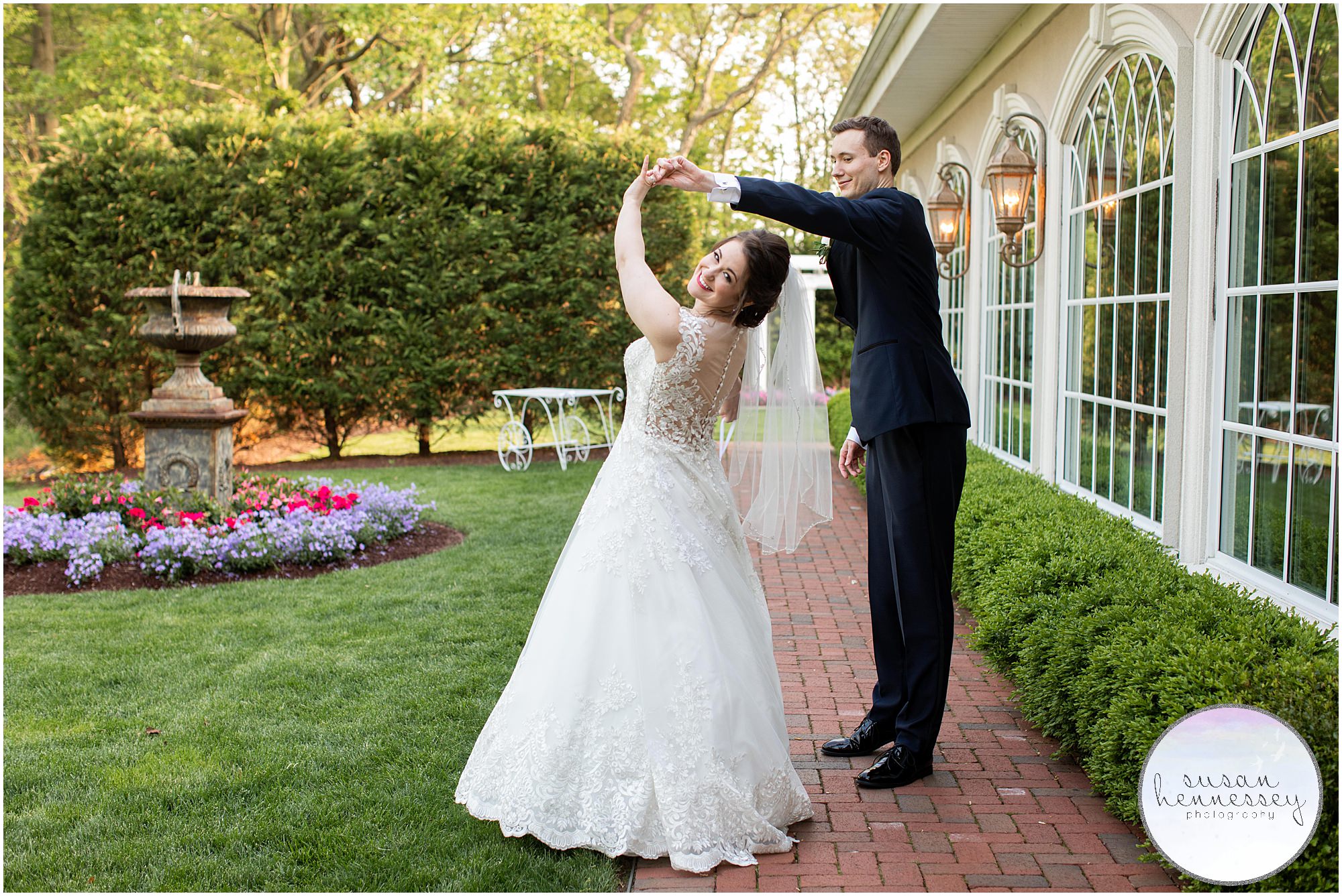 A groom twirls his bride on their wedding day.