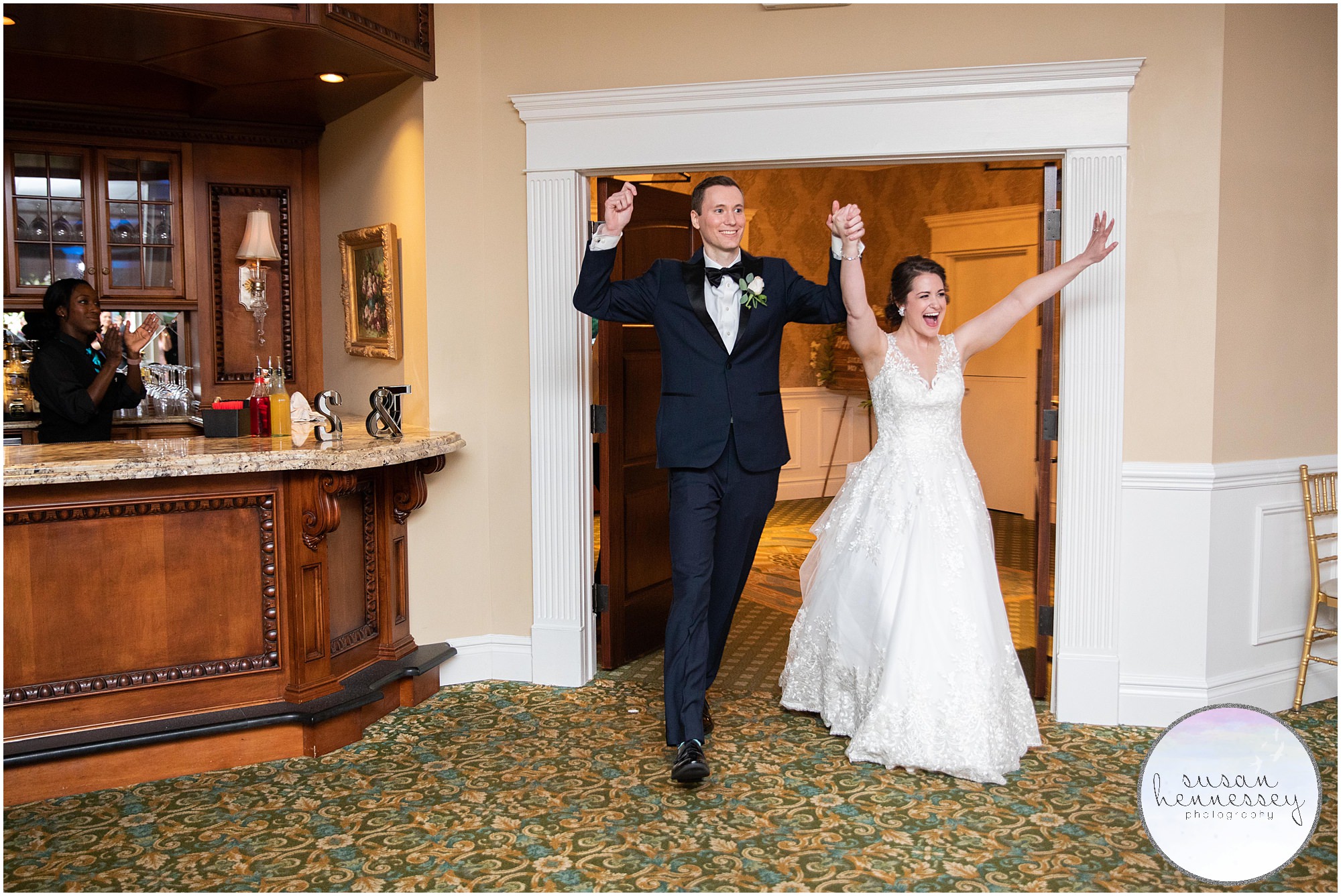 A bride and groom enter their reception