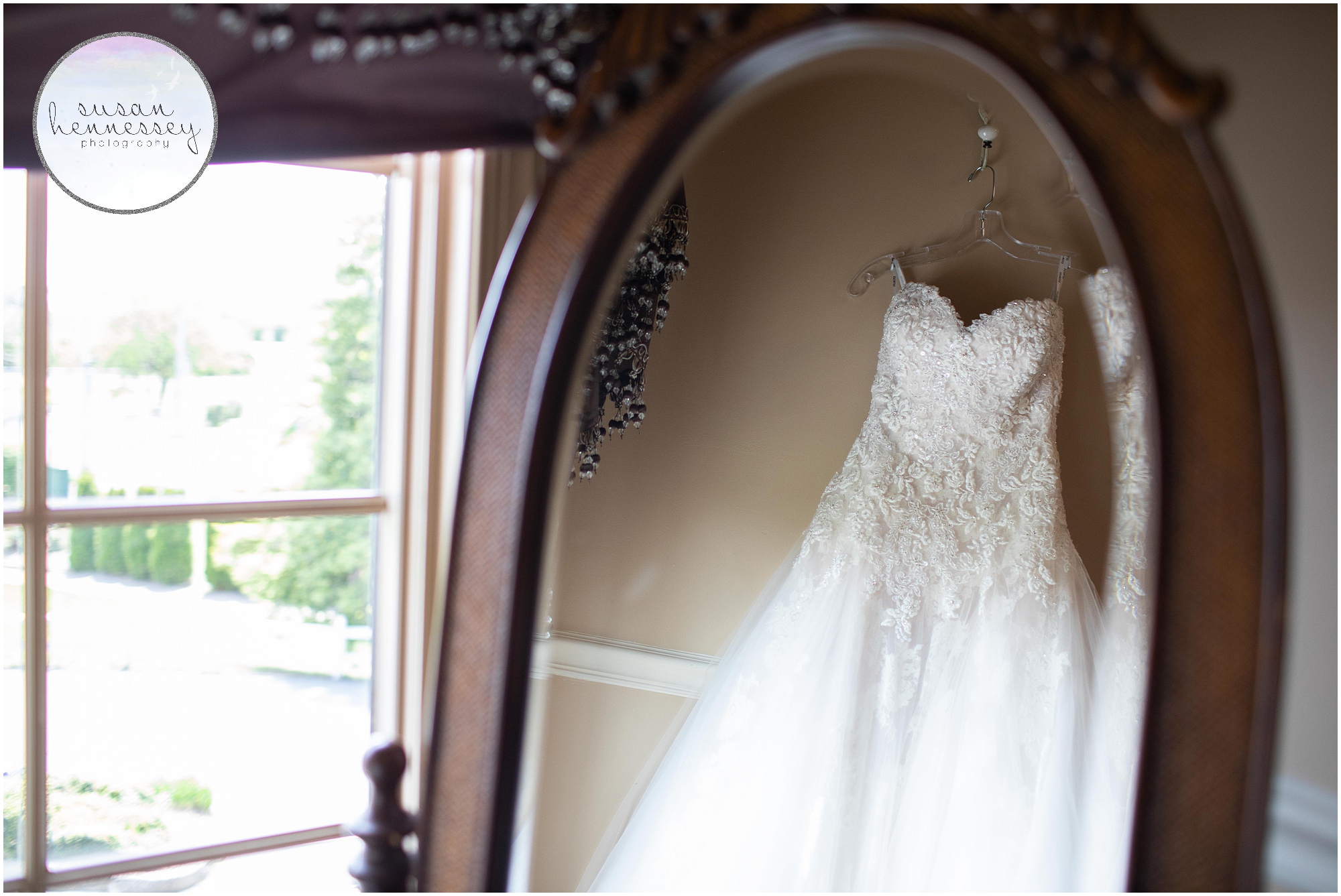 The bride's wedding dress hanging in bridal suite.