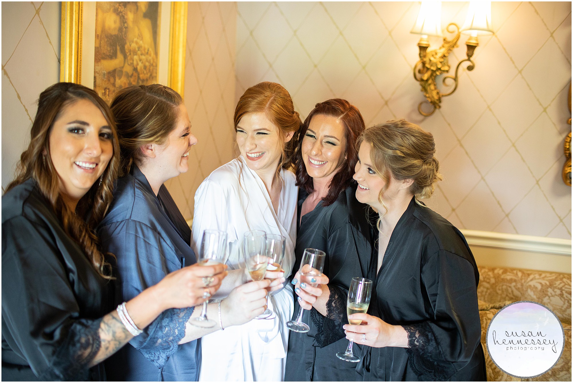 A bride and her bridesmaids with champagne.