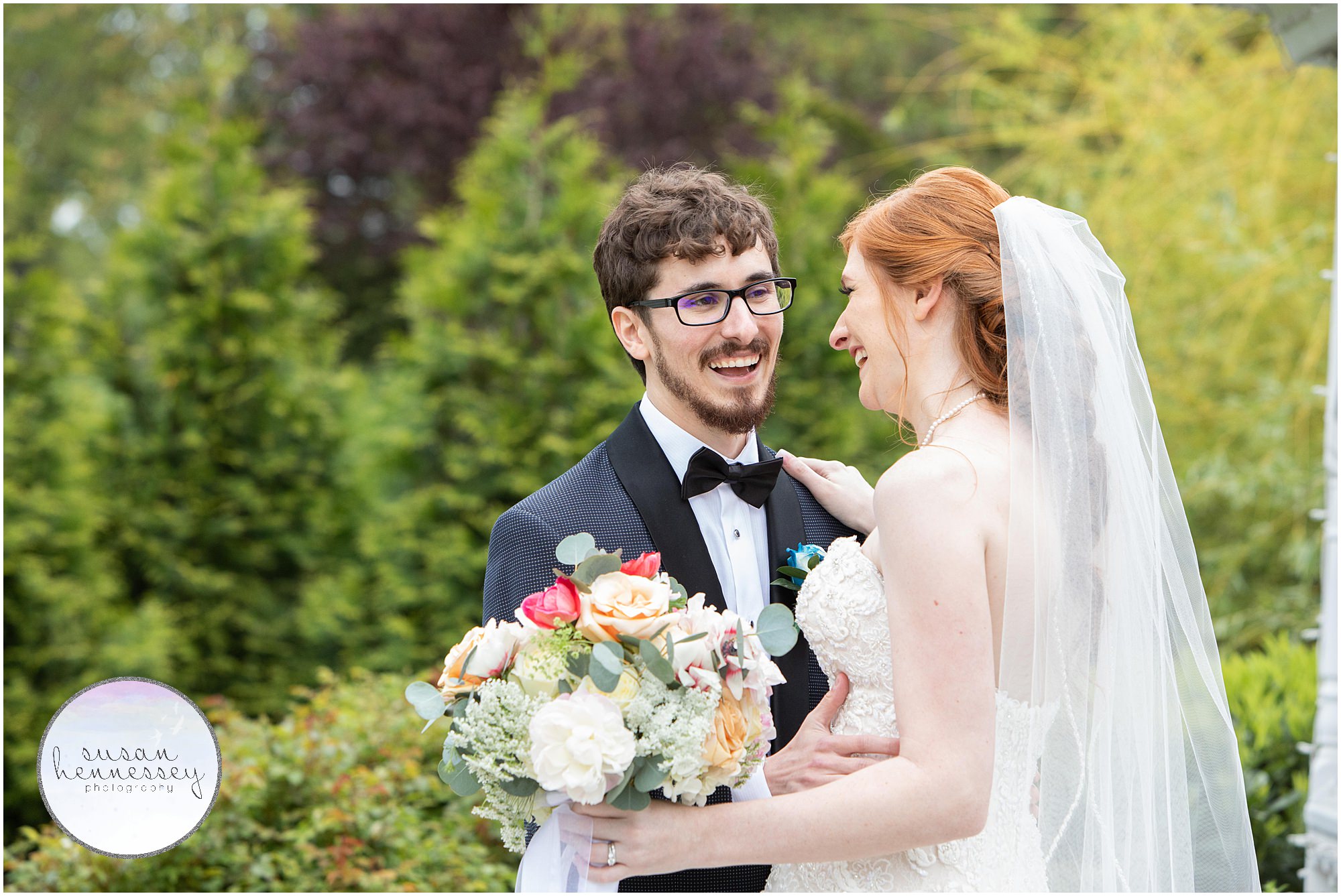 A bride and groom laugh on their wedding day