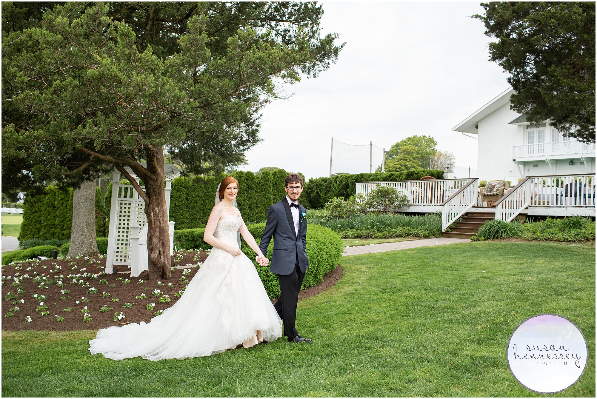 Bride and groom walk on the grounds of Greate Bay Country Club