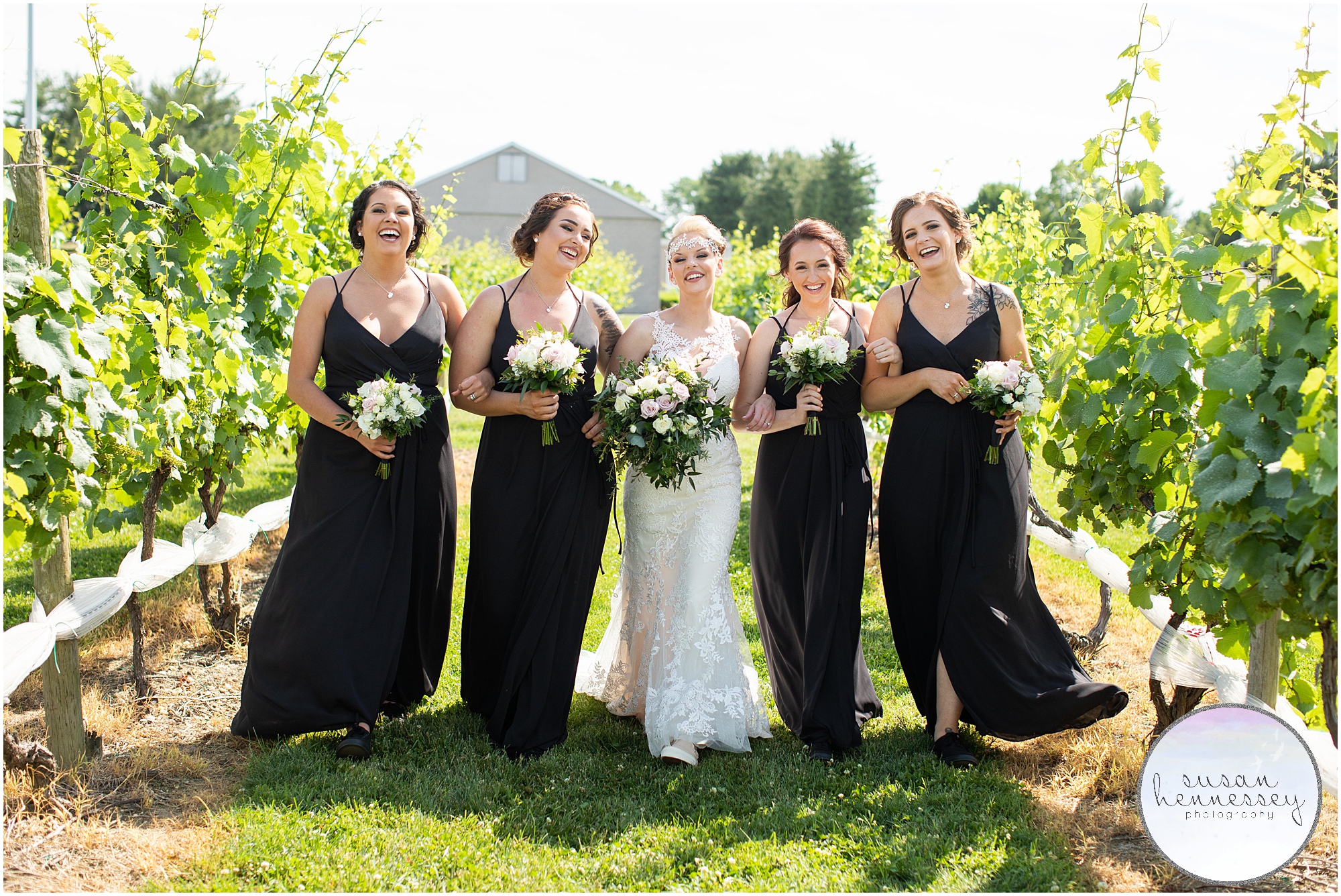 Bride and bridesmaids in the vineyard of Tomasello Winery
