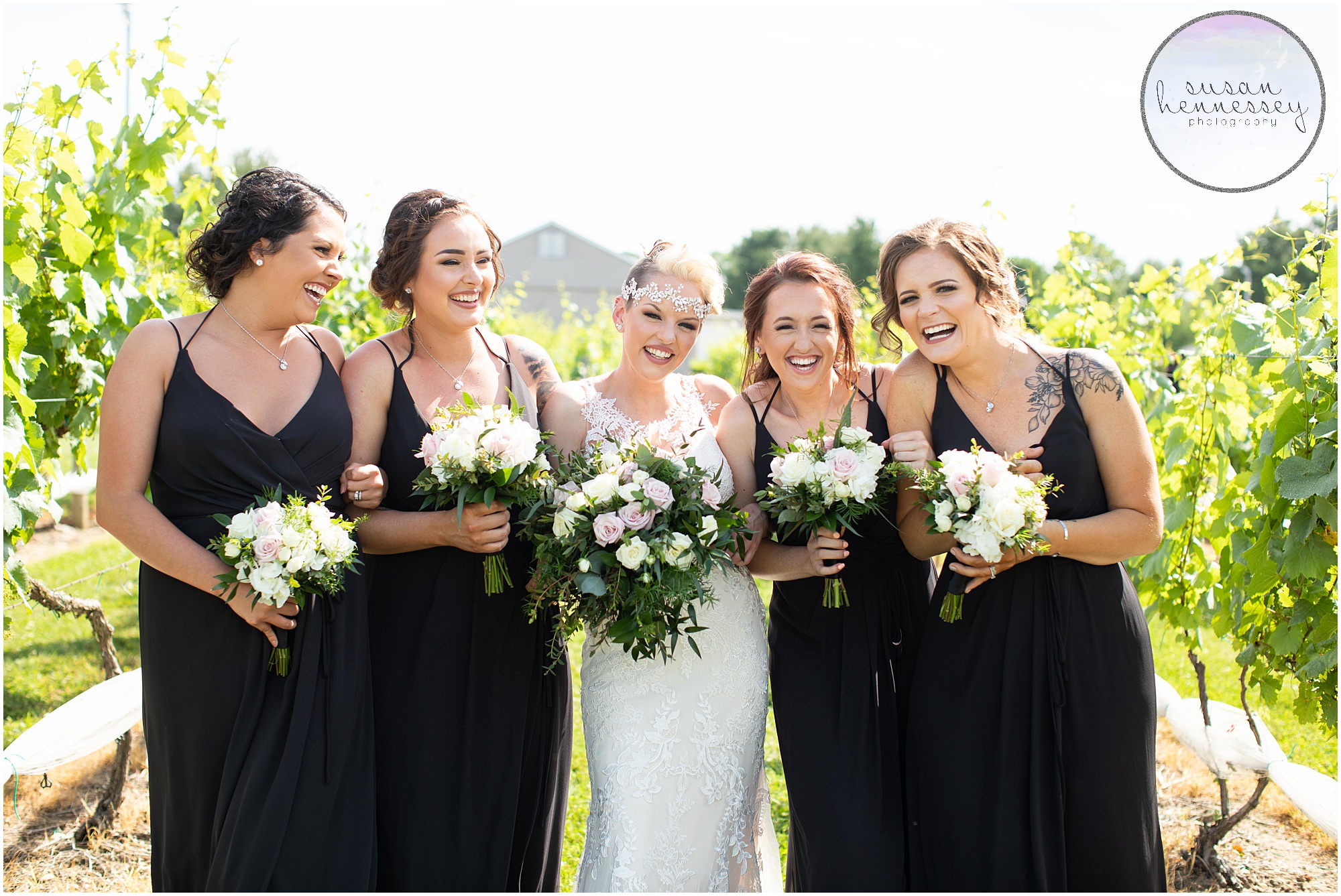 Bride and Bridesmaids laugh on wedding day