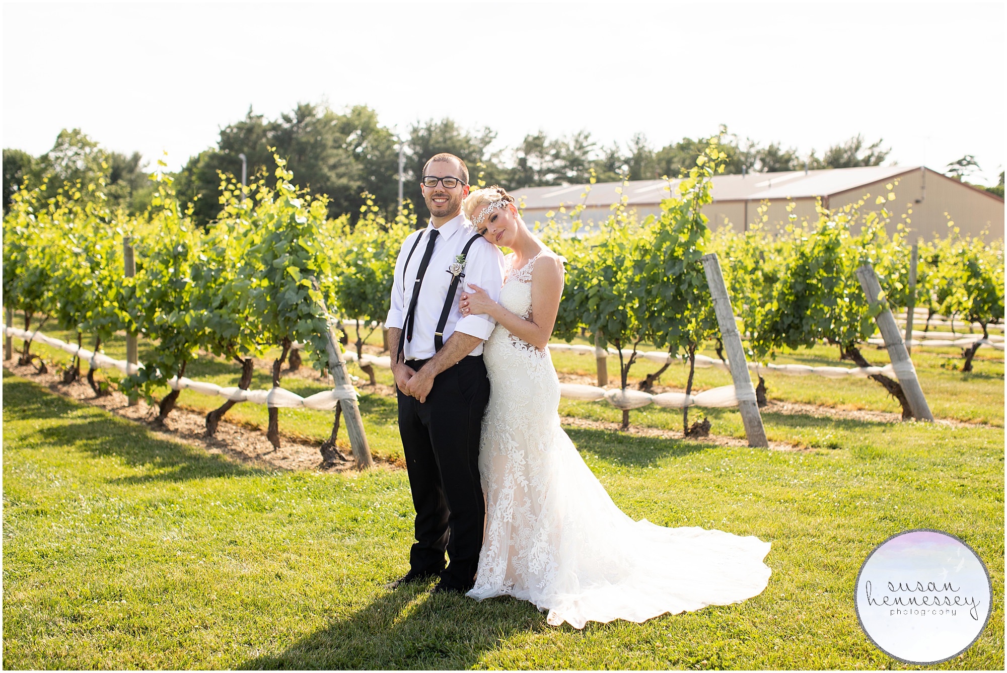 bride rests her head on grooms shoulder in the vineyard