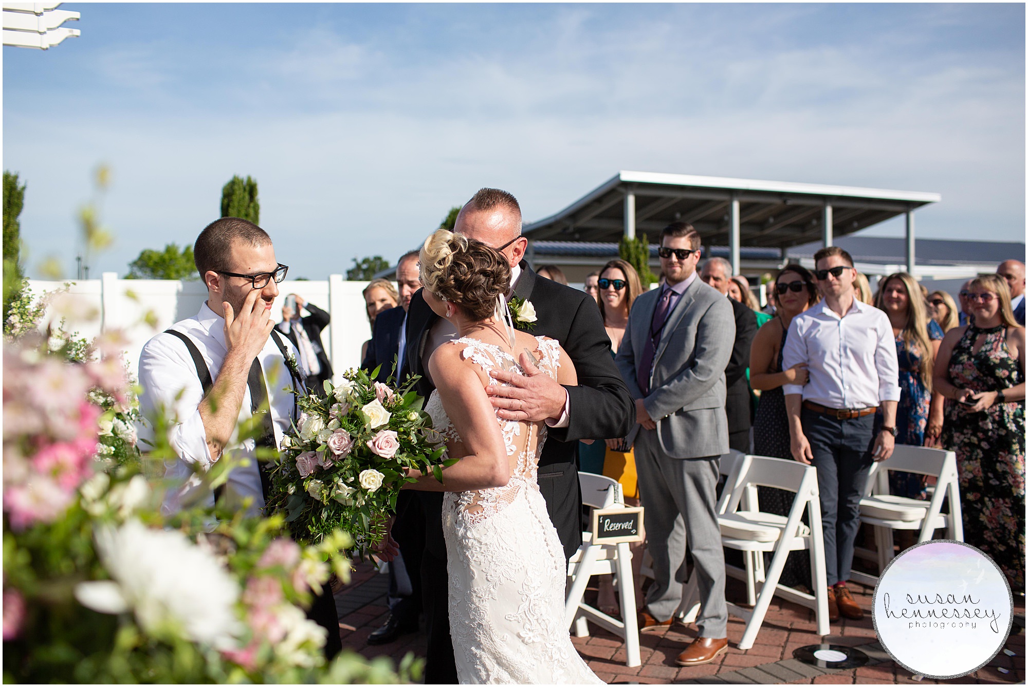 father of bride kissing daughter on cheek