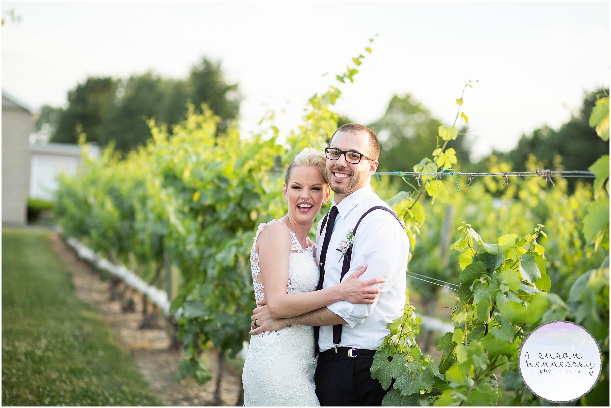 newlyweds pose in the vineyard