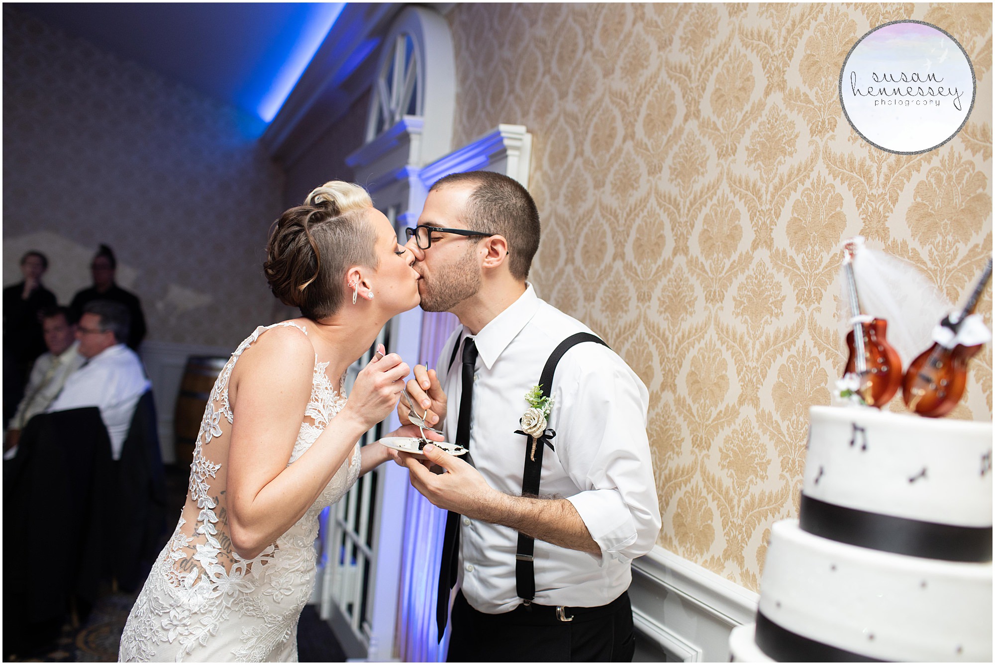 bride and groom kiss after eating cake