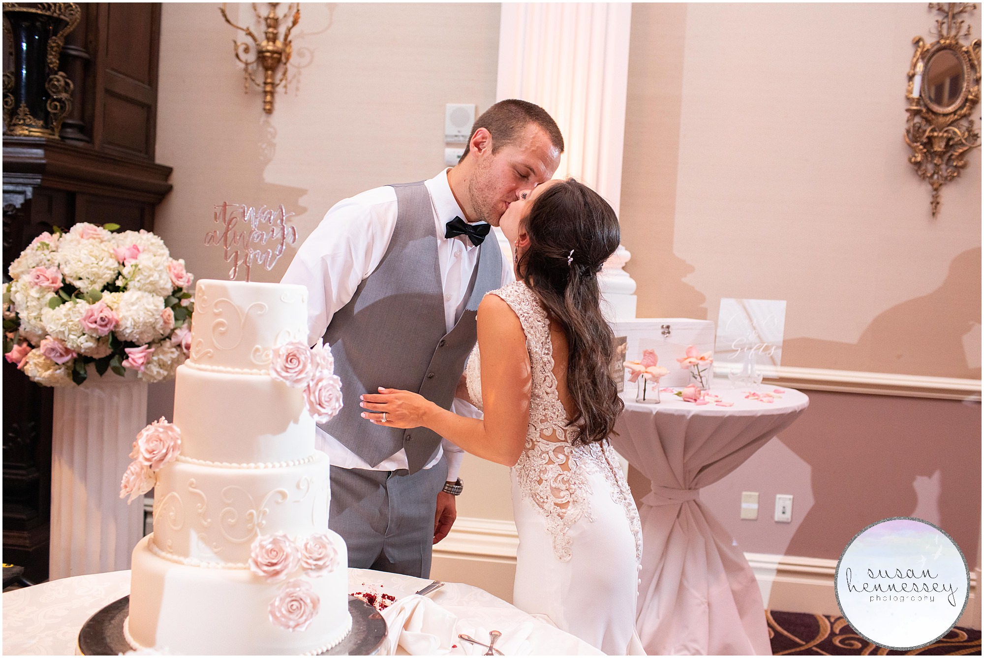 A bride and groom kiss after cutting their cake at their Palace at Somerset Park wedding