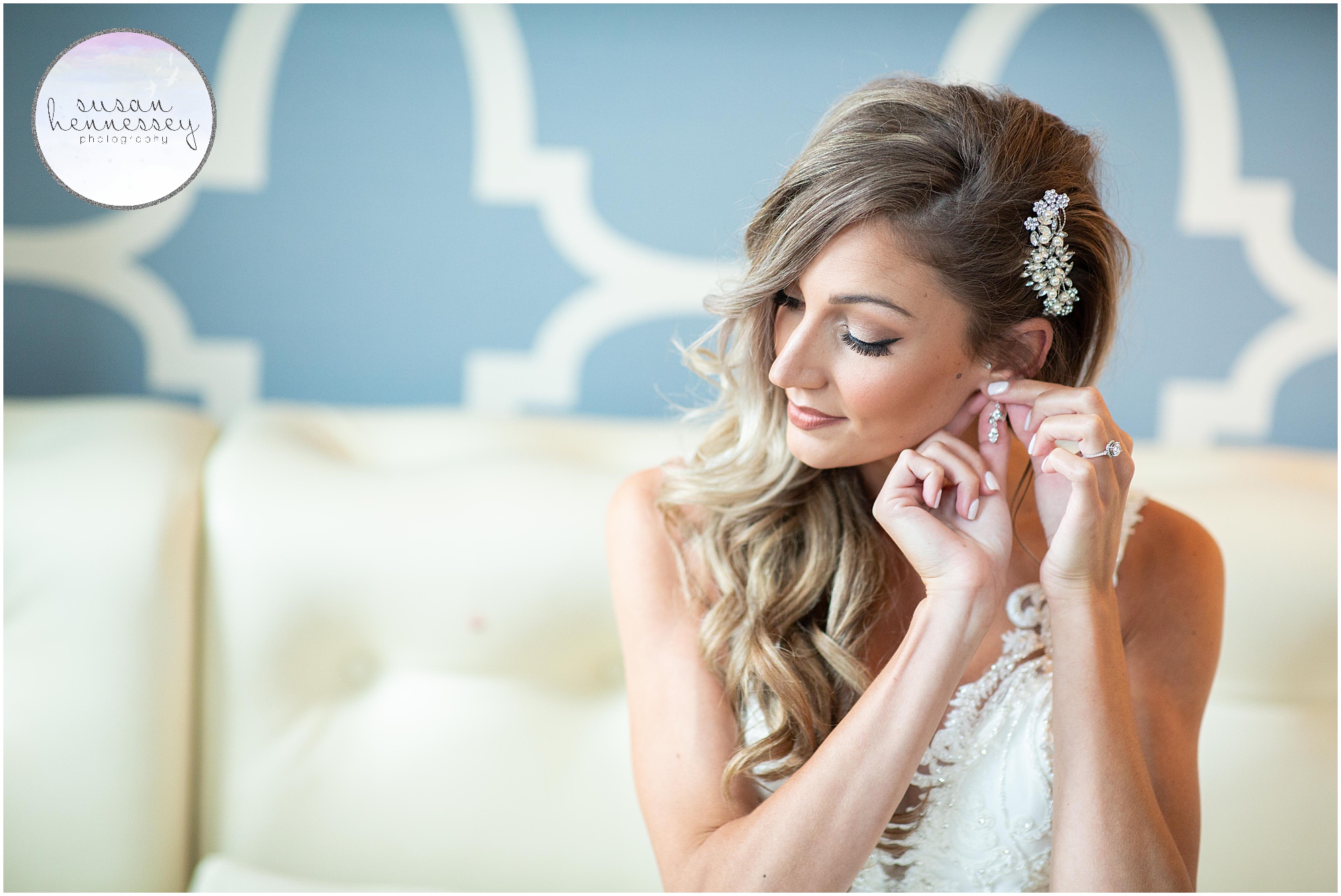 Bride puts on her wedding day earrings.