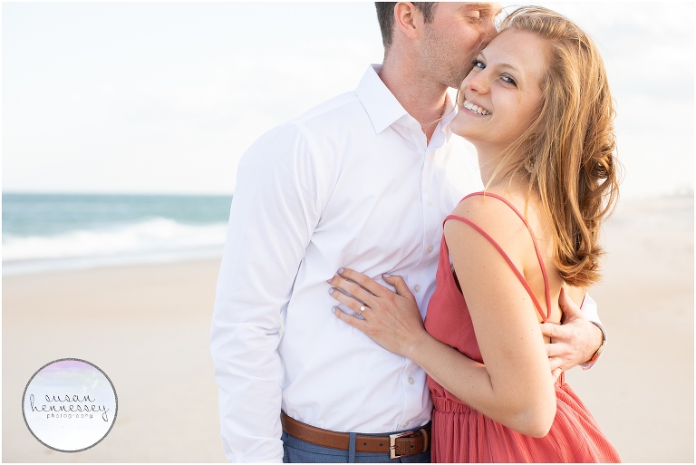 A happily engaged couple at the shore.