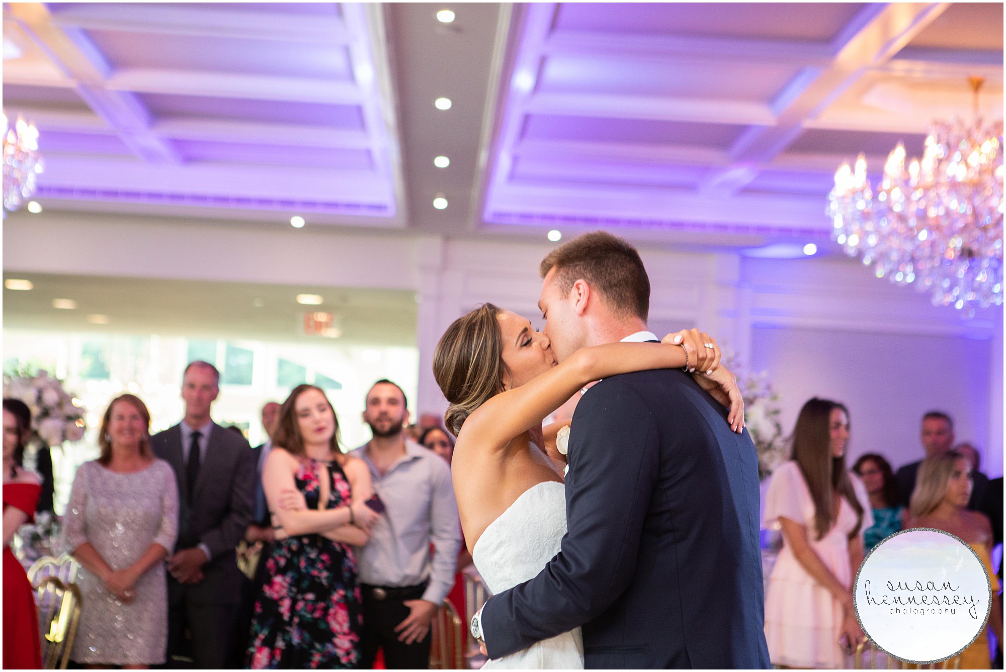 Bride and groom share a kiss during their first dance as a married couple.