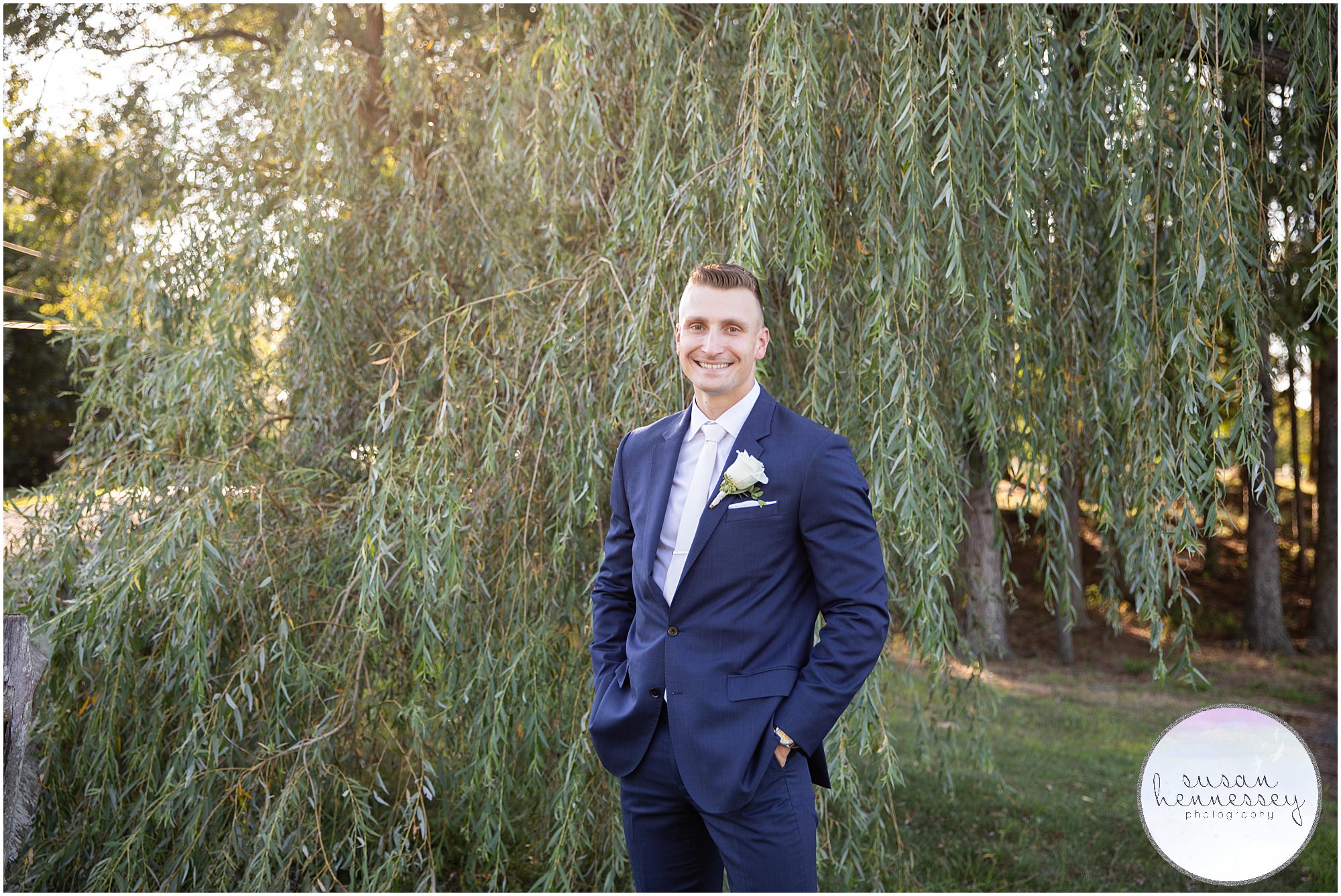 Groom portraits in front of willow tree