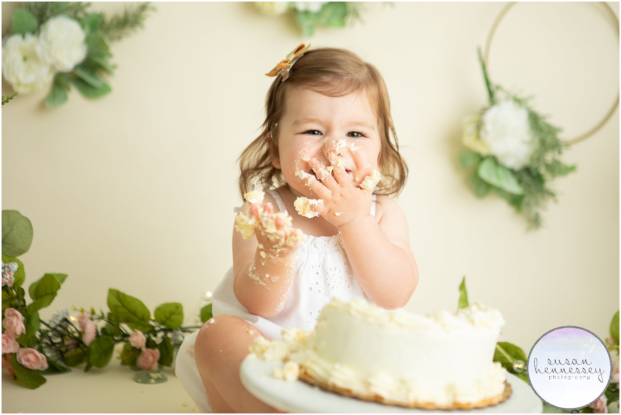 Happy girl laughs at her cake smash photoshoot
