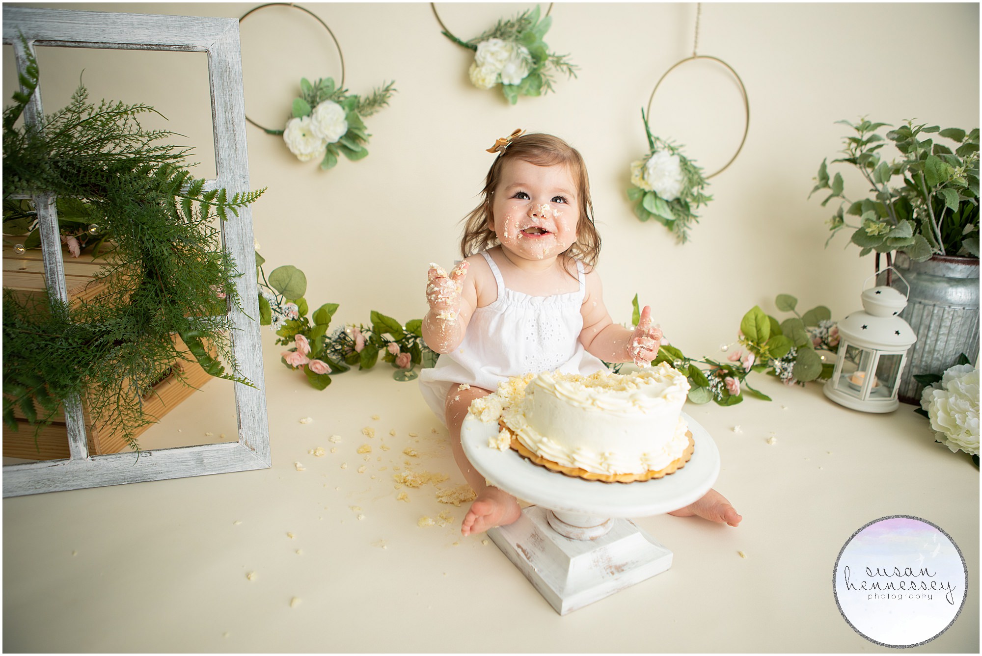 Cake smash session filled with greenery and white color palette