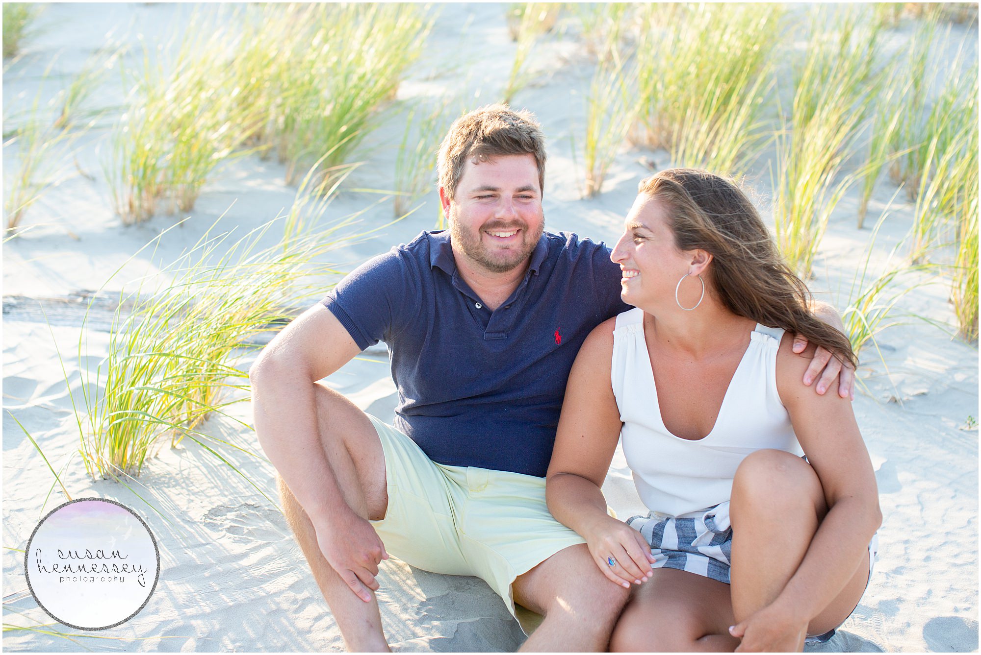 A couple sites on the beach at their Wildwood Crest engagement session