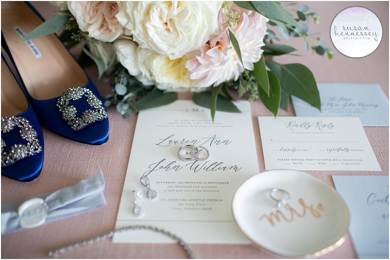 Bridal details featuring the bride's bouquet, invitation, wedding bands and blue manolo blahnik shoes.
